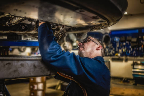 istock Skilled Caucasian Auto Mechanic Repairing Car in Workshop 2197500434
