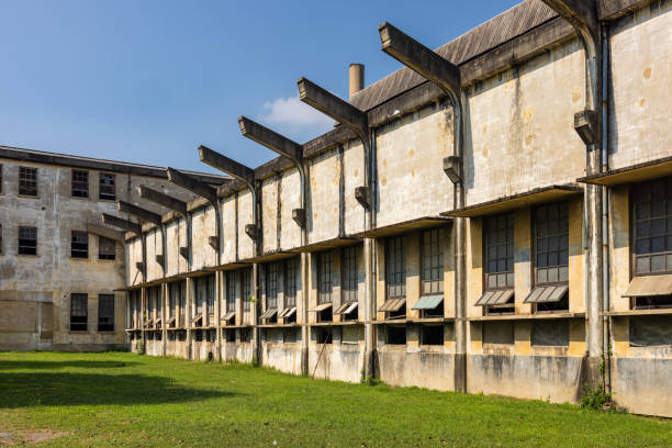 istock Historic Industrial Building with Large Windows and Open Green Space 2197502007