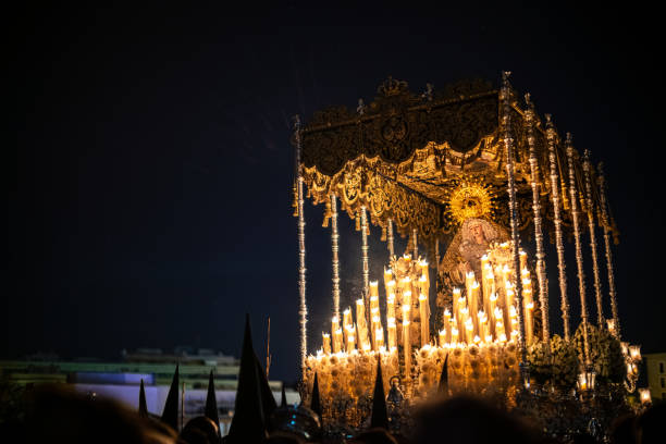 istock Seville, Spain, Apr 10 2017, Holy Week Religious Procession with Lanterns and Decorative Canopy at Night 2197505108