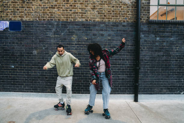 istock Young couple dancing with roller skates in urban setting 2197517200