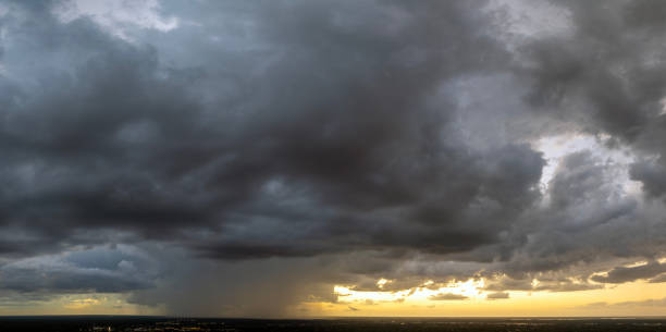 Heavy rainfall during summer thunderstorm in Florida at sunset.