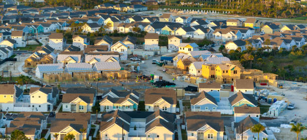 istock Construction in new developing suburban area. Development of residential housing in American suburbs. Real estate market in the USA 2197522351