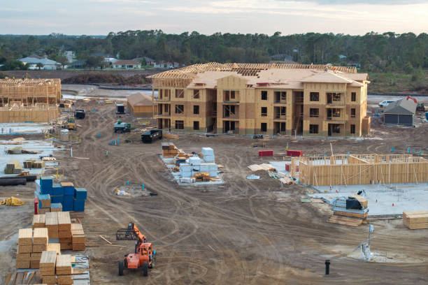 istock Wooden apartment buildings under construction in new developing suburban area. Development of residential housing in Florida suburbs. Real estate market in the USA 2197522387