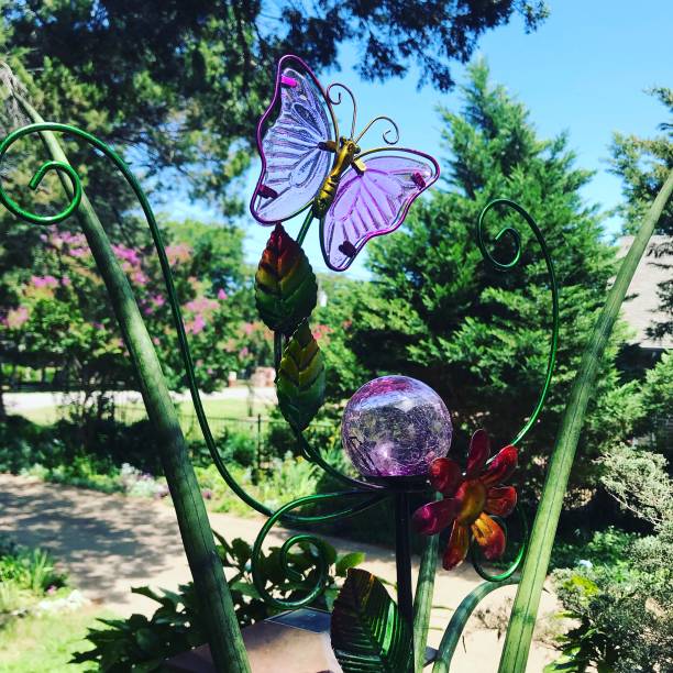 istock A butterfly and globe decoration in a garden 2197522483