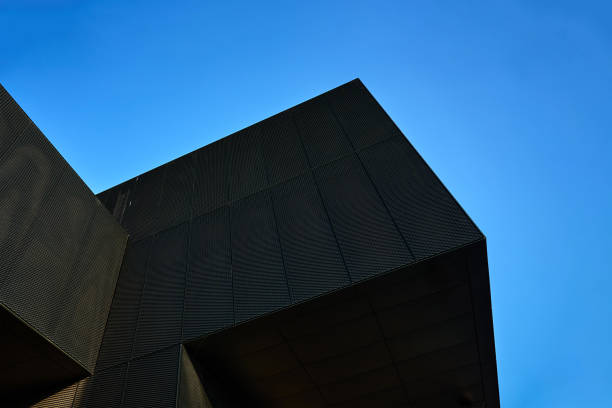 istock Modern black building with geometric design against blue sky 2197523682