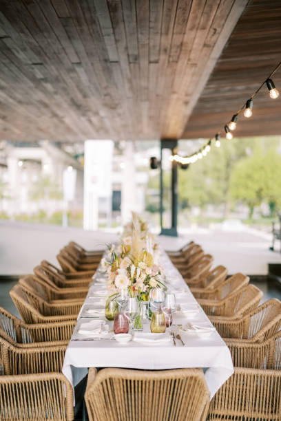 istock Wicker chairs stand along a long festive table in the restaurant hall 2197524607