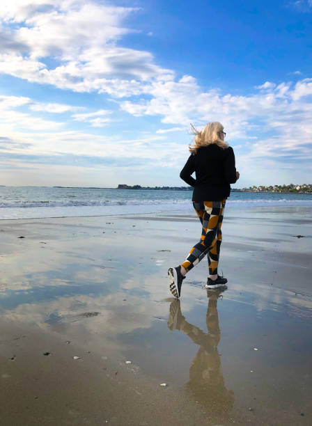 Active Senior Woman Jogging on Beach