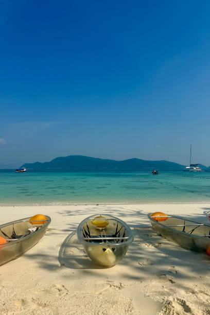istock Transparent Kayaks on a Tropical Beach with Turquoise Water 2197526642