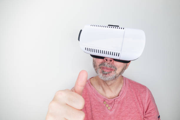 Bearded man wearing a virtual reality headset is giving a thumbs up, showcasing his enthusiasm and satisfaction with innovative technology and immersive digital experiences