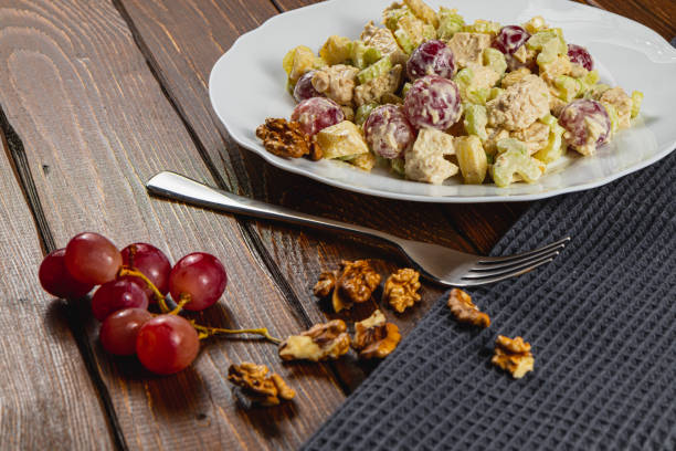 Delightful chicken salad with grapes and nuts on a rustic wooden table