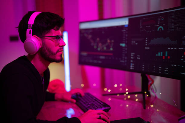 istock Young man focusing on financial charts and data analysis in a modern workspace with vibrant lighting 2197537275