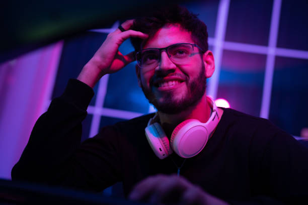 istock Enthusiastic gamer in a vibrant gaming setup enjoying an immersive experience during nighttime 2197537361