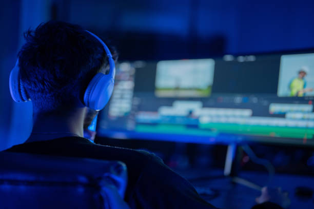 istock Editing a video project in a dark room with blue lighting and focused concentration 2197537488