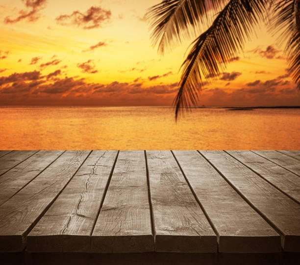 istock Empty wooden table top with tropical ocean sunset background 2197537718