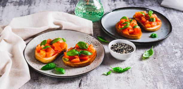 istock Appetizing bruschetta with tomatoes, garlic and basil on a plate on the table web banner 2197539026