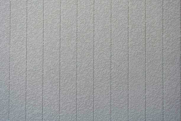 White concrete background wall with vertical line ribbed. Stripes as a texture.