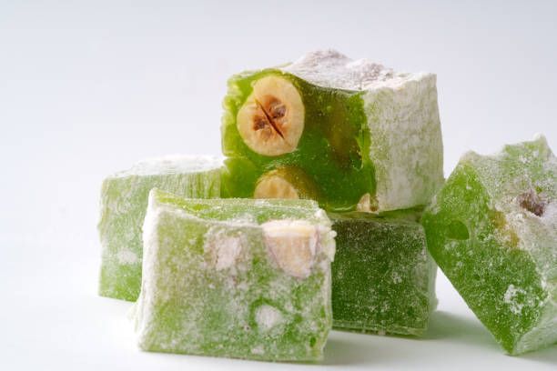 istock Delightful green Turkish delight with nuts arranged artistically on a clean background 2197539644