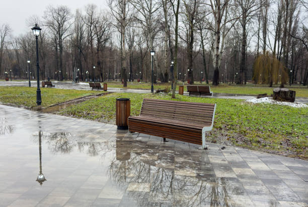 istock A park bench is sitting in a wet park 2197542716