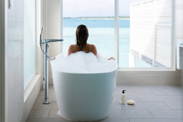 istock Rear view of a woman taking a bath. 2197544611
