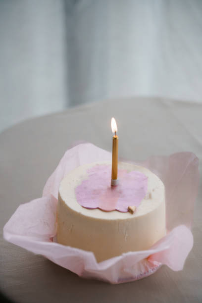 istock Simple Elegant Birthday Cake with a Single Candle on a Table 2197545847