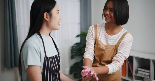 istock Two Asian siblings are happily cooking together. 2197545954