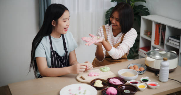 istock Two Asian women happily cooking together. 2197545989