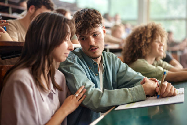 istock Young college couple talking having a class at lecture hall. 2197546102