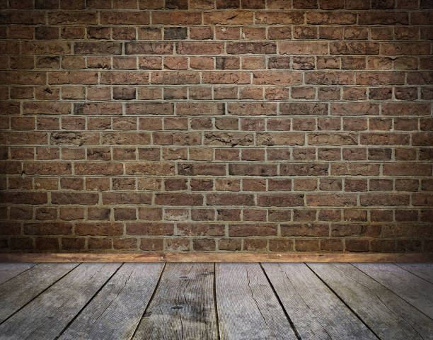 istock Old bricks wall and wooden floor background with vignette effect. 2197546191
