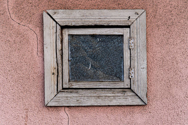 istock Aged Wooden Window on Cracked Pink Wall 2197546242