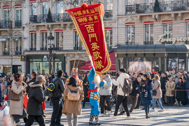 Paris,France-02.02.2025 Colorful performers and vibrant dragon dancers fill the iconic Champs-Elysees during the lively Chinese New Year parade, welcoming the Year of the Dragon in 2025.