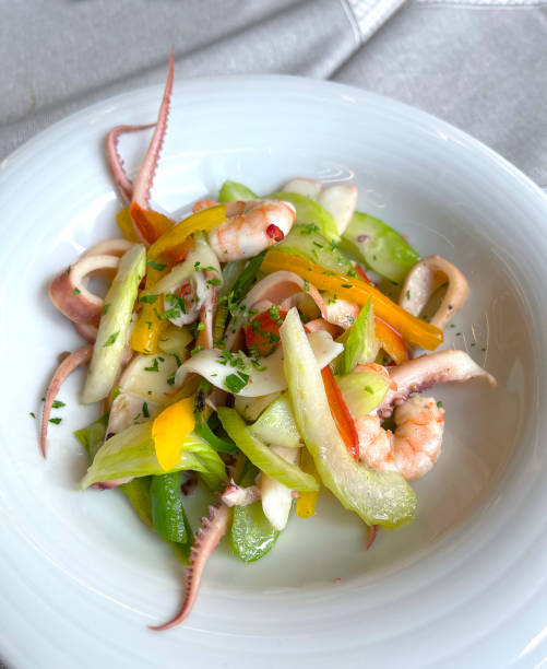 istock Mix of seafood and vegetables on plate. 2197550082