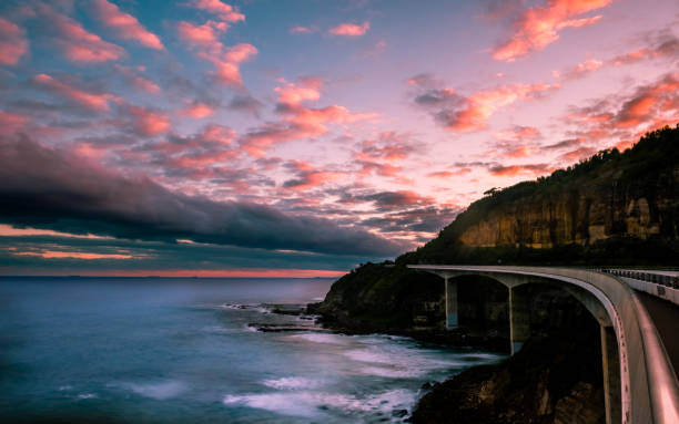 istock Ocean view of Sea Cliff Bridge against sky during sunset 2197550932