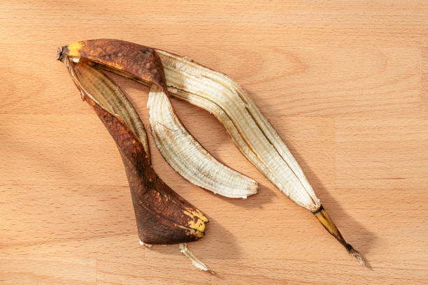 Blackened banana peel on wood surface. High resolution 42Mp studio digital capture taken with Sony A7rII and Sony FE 90mm f2.8 macro G OSS lens