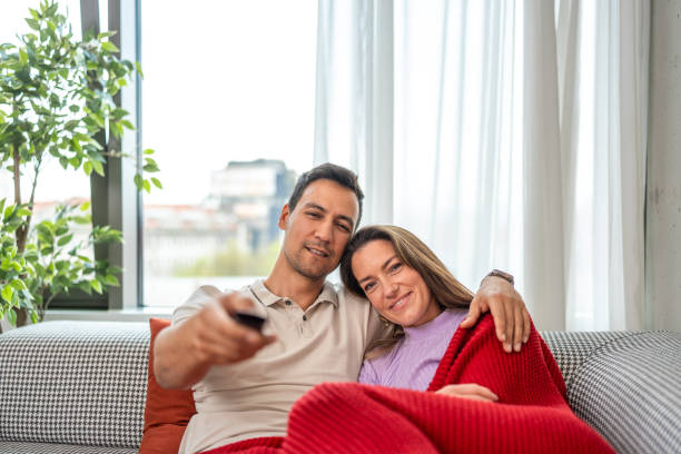 istock Cozy Couple Relaxing Indoors Watching Television 2197553015