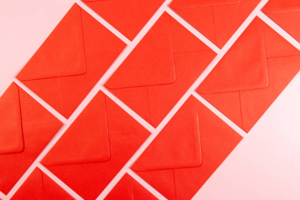 Top view of red envelopes on pink background. Post flat lay. Copy space.