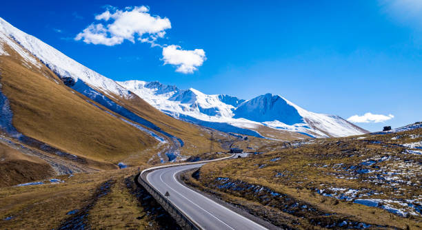 istock Aerial view  on the road surrounded by winter Landscape view 2197556400