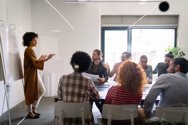 istock Diverse employees gathered in the office having fun during brainstorming while discussing new ideas 2197556991
