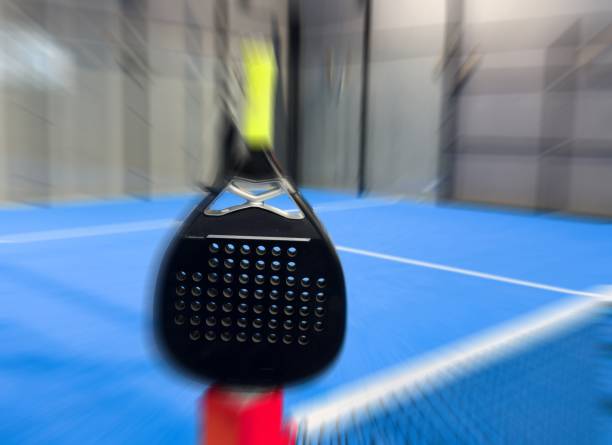 istock padel racket on a padel blue court with a ball 2197557170