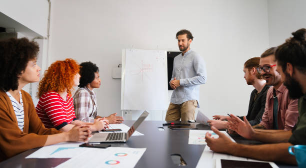 istock Diverse employees gathered in the office having fun during brainstorming while discussing new ideas 2197557207