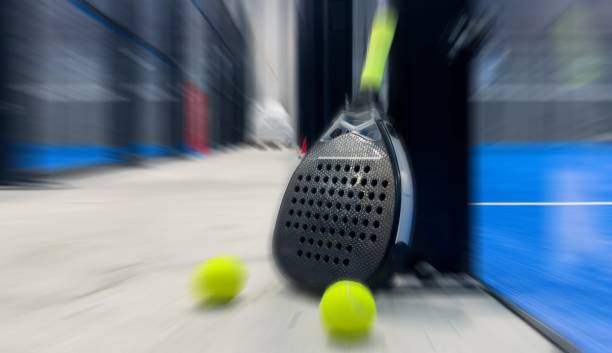istock padel racket on a padel blue court with a ball 2197557265