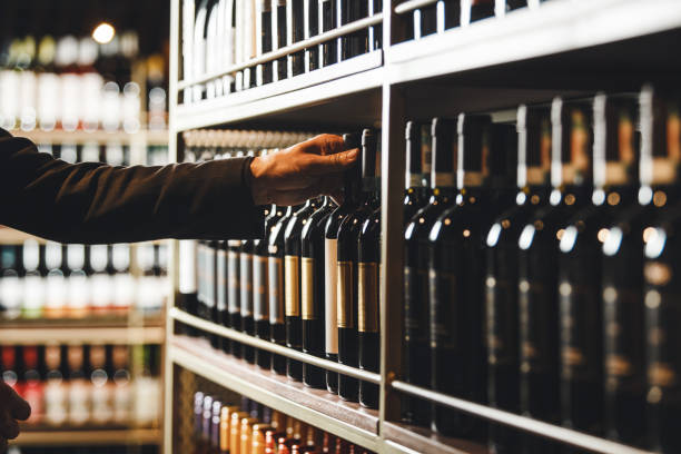 istock Expert Sommelier Selecting Fine Bottle From Extensive Wine Collection at High-End Establishment 2197557305