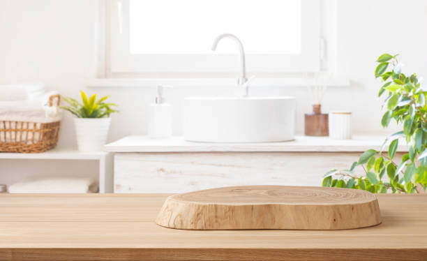 istock Wooden podium for product display on blurred bathroom sink background 2197557843