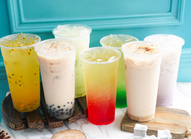 istock Assorted Iced Tea include Passion Fruit, Pearl, Taro, Pomegranate, mint, lime, milk, wheat, germ, and ice cube in tall glass served on a wooden board side view of taiwan cold drink 2197559878