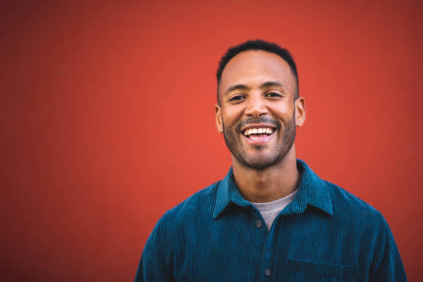 istock Handsome man laughing over maroon bacckground 2197562178