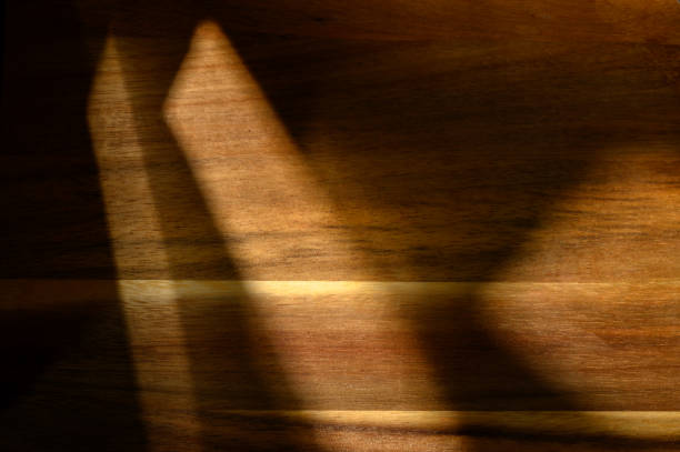 istock Shadows dance gracefully across a wooden surface during twilight hours, creating an enchanting ambiance 2197562382