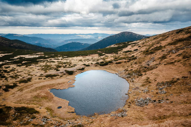 istock Serene Mountain Lake with Reflective Waters 2197562465