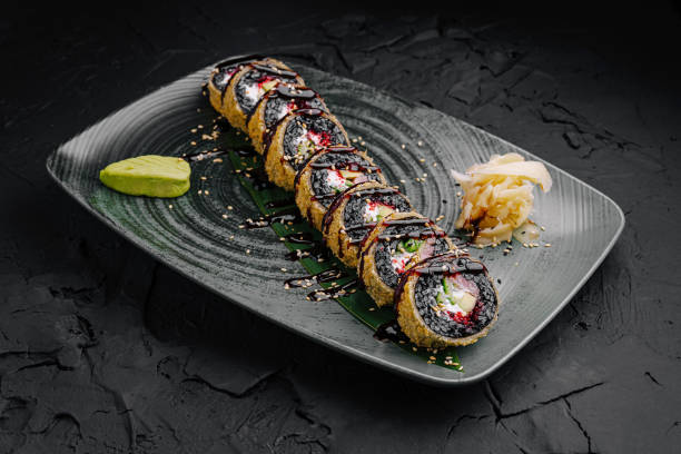 istock Sushi rolls beautifully arranged with wasabi and pickled ginger on a textured plate at a modern dining setting 2197562835