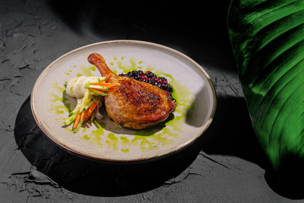 istock Elegant dish of seared duck breast garnished with vegetables served on a decorative plate 2197563116