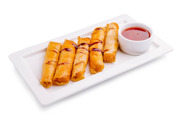 istock Delightful crispy spring rolls served with sweet and tangy dipping sauce on a white platter 2197563146