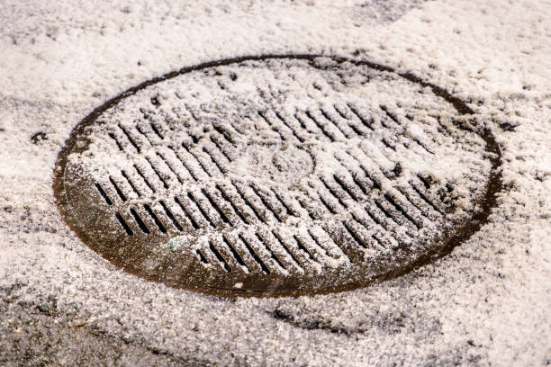 Storm rain cover covered with freshly fallen snow at nighttime in Queens, New York